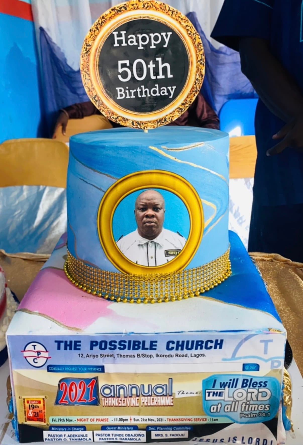 Personalized blue marble milestone cake with gold details, a framed customer-supplied portrait, and a celebration topper